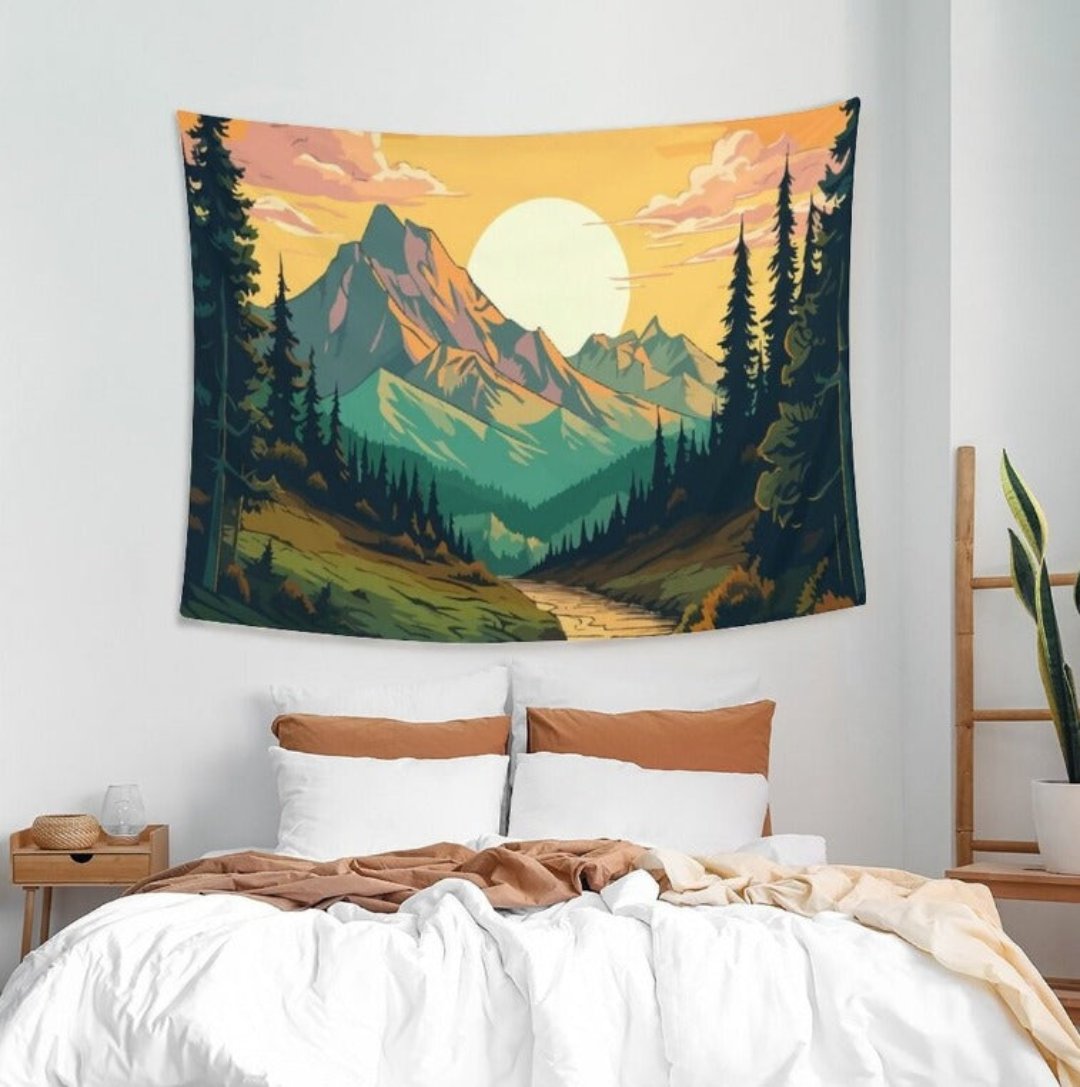 Mountain and forest landscape tapestry with a golden sun above a bed.