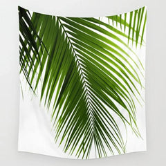 White tapestry printed with large green palm leaves.